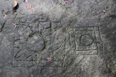 Rock carvings in the Siem Reap River showing intricate ancient designs from the 11th to 12th century