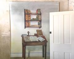 Painting of hanging shelf and small desk with writings at Edgar Allan Poe National Historic Site in Pennsylvania