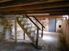 Basement of the Edgar Allan Poe House in Philadelphia with stone walls and wooden beams