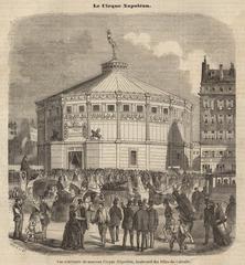 Exterior view of Cirque d'Hiver, historic oval polygon circus building with Corinthian columns in Paris