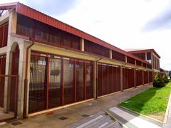 Exterior view of Museo del Ferrocarril in Ponferrada with railway tracks and historic train cars