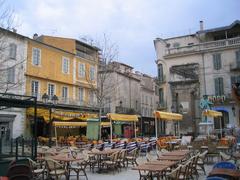 Historic Place du Forum square in Arles, France with traditional buildings and outdoor cafes