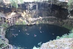 Scenic view of Cenote Zaci with lush greenery and clear water