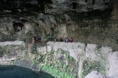 Cenote Zaci natural sinkhole with turquoise water surrounded by rocky walls and lush greenery