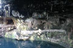Cenote Zaci natural sinkhole with clear water surrounded by rock formations and greenery