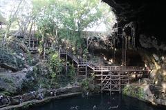 Cenote Zaci crystal clear water surrounded by rocky walls and greenery