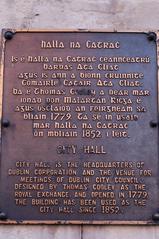 Information board about Dublin City Hall in Irish Gaelic type and English near Dublin Castle