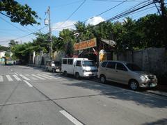 Pinagtipunan Circle at MacArthur Highway in Potrero, Malabon City with signs for Governor Pascual Avenue and Malabon Zoo