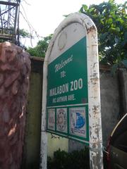 Pinagtipunan Circle and MacArthur Highway intersection in Potrero, Malabon City with visible road signs and urban surroundings