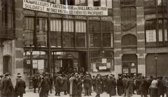 Historic image of Belgian general strike in 1913 showing the Maison du Peuple with banners urging peaceful protest