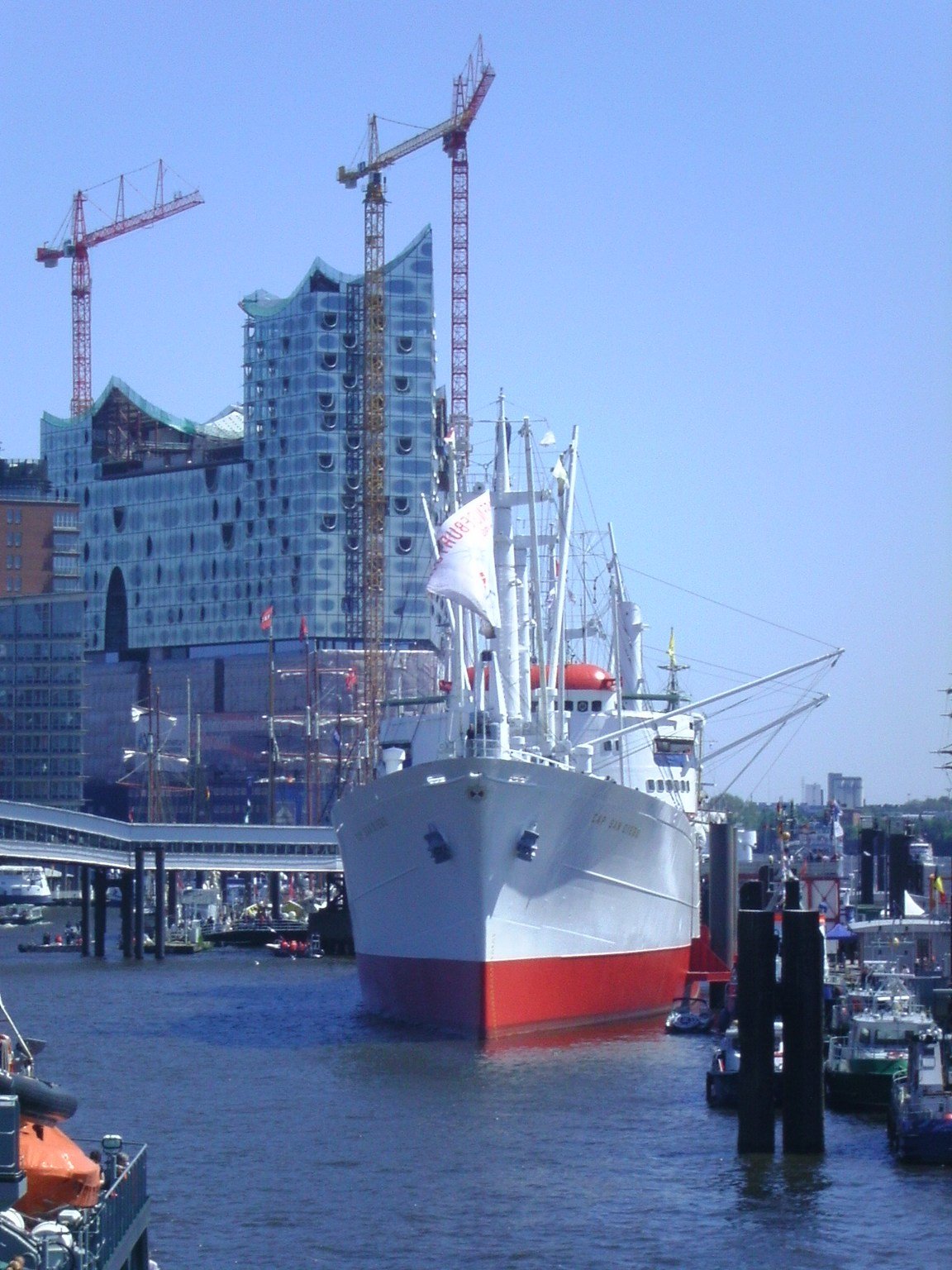 Museum ship Cap San Diego docked with Elbe Philharmonic Hall under construction in the background