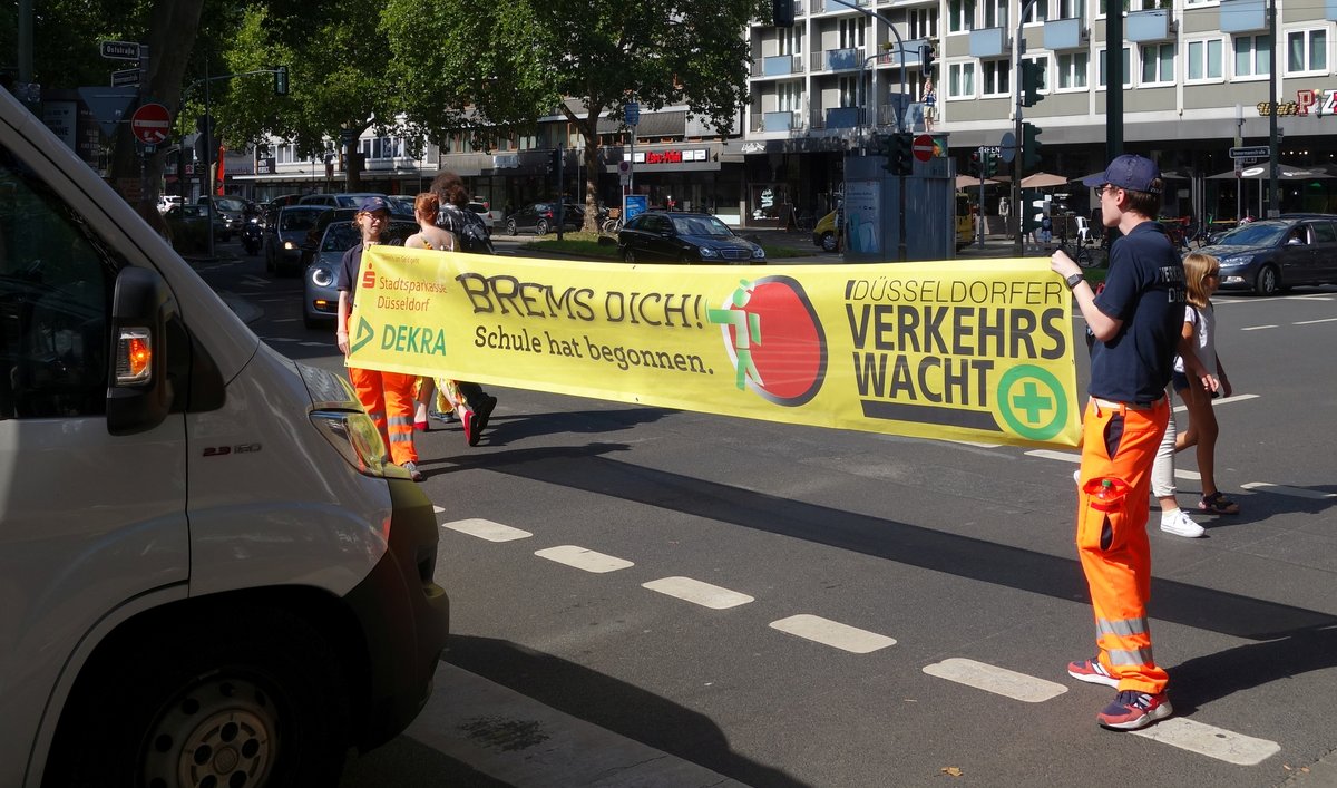 Traffic safety campaign sign Brems dich Schule hat begonnen with traffic cadets in Düsseldorf August 2020
