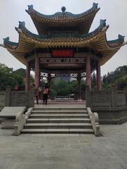 Guangzhou Insurrectional Martyr Cemetery Park with tall monument and trees under blue sky