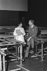 Black and white photo of Dutch television presenter Mies Bouwman and Fred Oster preparing for Aktie Bisschop Bekkers Stichting event at Carré theater in Amsterdam, 1969