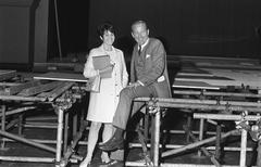 Black and white photograph of presenter Mies Bouwman and Fred Oster during preparations for Bisschop Bekkers Stichting campaign at Carré theater Amsterdam, May 8 1969