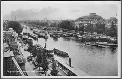Old postcard of Amsterdam showing Amstel river and Carre theatre
