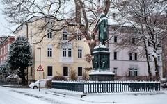 Statue of Uhland monument in Tübingen covered in snow