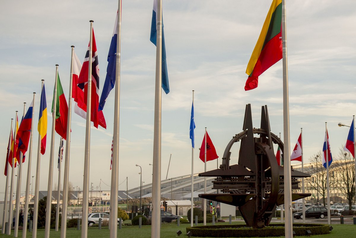 NATO country flags waving at the entrance of NATO headquarters in Brussels