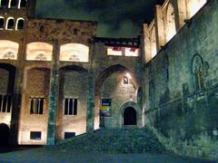 Historic stone staircase of Palau Reial Major in Barcelona with intricate metal railings and ancient architectural details