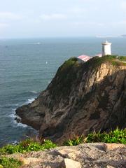 Cape D'Aguilar Lighthouse on rocky coastline in Hong Kong