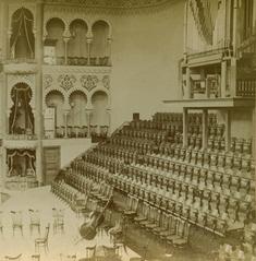 Interior view of Massey Hall concert venue with wooden walls and seats