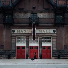 Entrance to Massey Hall with people walking by and banners displayed