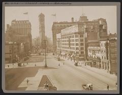 Longacre Square south bustling city scene with vintage cars and pedestrians