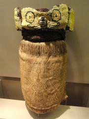 Mummy mask from Cerro Uhle, Ica Valley, Peru made of painted cotton cloth, wool turban, and fox muzzle covered with feathers