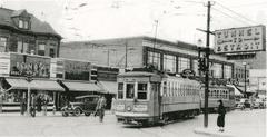 Vintage black and white photo of streetcars on Ouellette Avenue at Wyandotte Street intersection in downtown Windsor, 1938