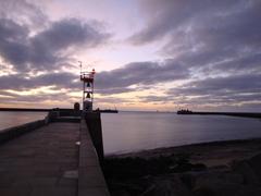 Sunset view at the entrance of Le Havre port with calm sea and horizon