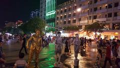 Night scene of Nguyen Hue Walking Street in Ho Chi Minh City with illuminated buildings and bustling crowd