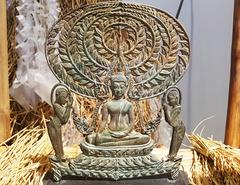 Gautama Buddha statue with disciples Moggallana and Sariputta surrounded by rice ears and straws at Bangkok Art and Culture Centre