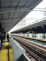 Osaka Metro Bentencho station platform with yellow tactile paving and train tracks