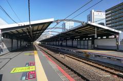 JR West Morinomiya Station Osaka Loop Line platforms with passengers and trains