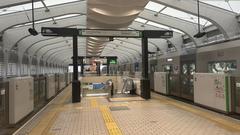 Osaka Port Station platform with railway tracks and overhead wires