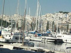 Harbor near Athens with boats docked and city buildings in the background on a clear day in July 2006