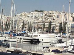 Harbor near Athens with boats docked and mountainous background on a clear summer day