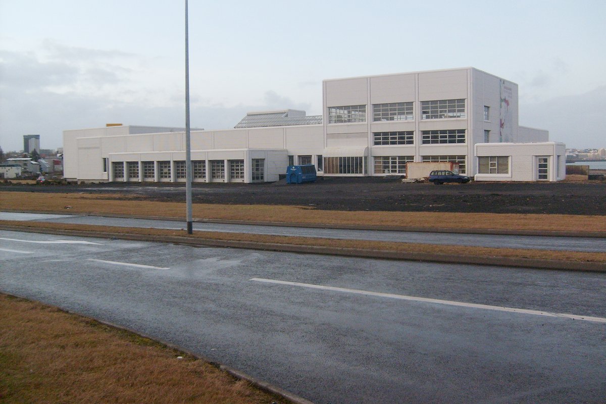 Modern building of Hochschule Laugarnes with glass facade and surrounded by greenery