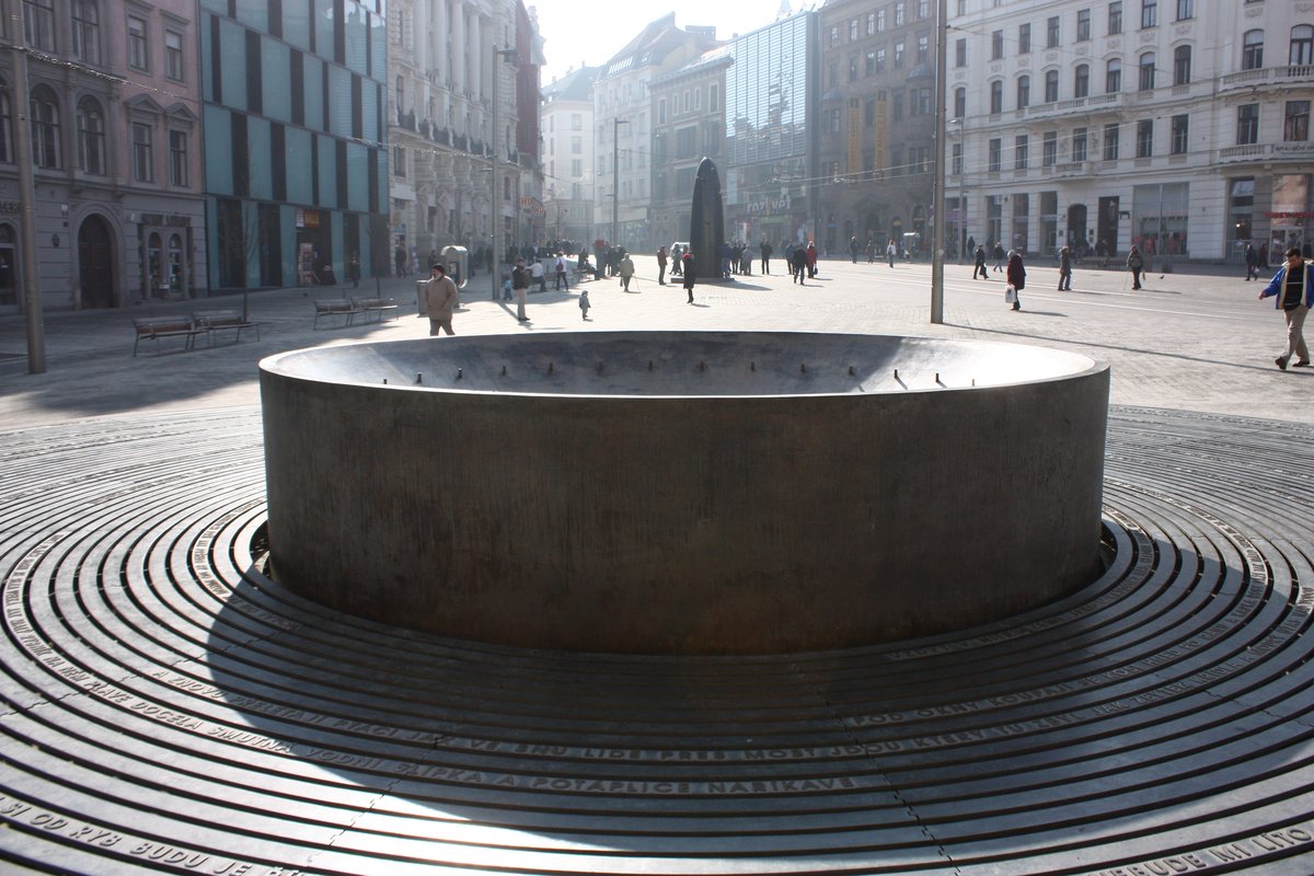 Fountain at Freedom Square in Brno with Brno Astronomical Clock in the background