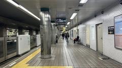 Osaka Metro Awaza Station platform with train tracks and station sign in Japan