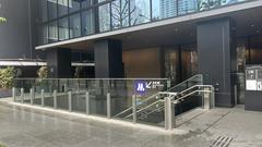 Entrance of Honmachi Station Osaka Metro with escalators and modern architecture