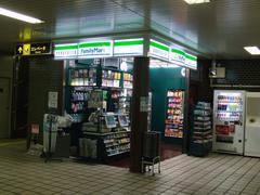 Eki-Fami Honmachi Station platform view with train and passengers