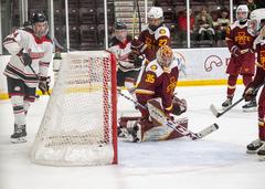 Minot State University Beavers and Iowa State University Cyclones players reacting to a goal in hockey game