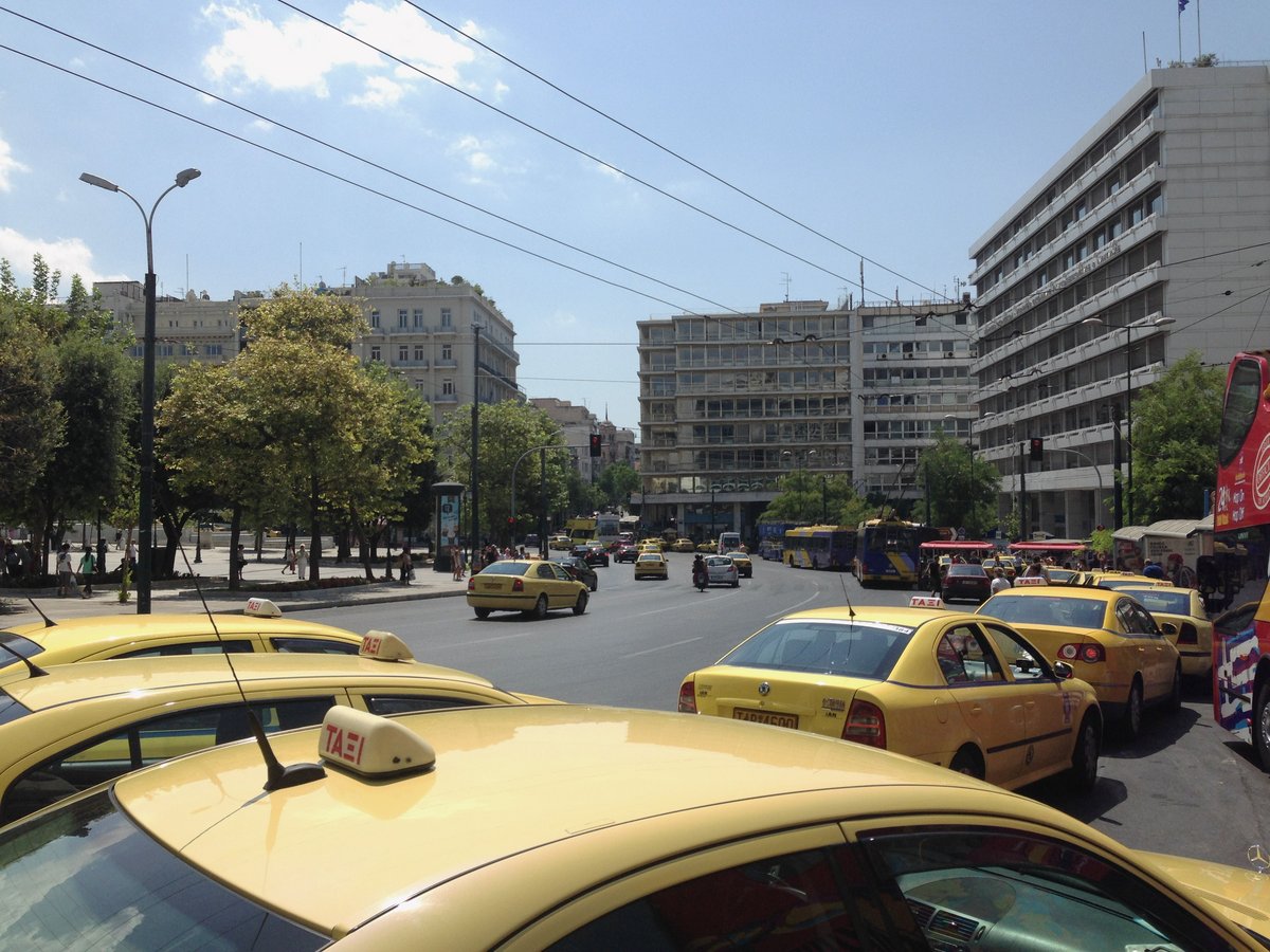 A row of many taxi cabs lined up in Syntagma Square, Athens