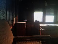 Interior view of Gaekwar's Baroda State Railway Saloon showcasing vintage wooden seating and ornate decor