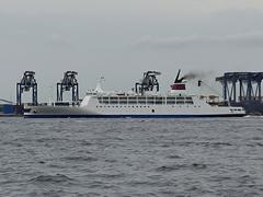 Cargo ship entering Tokyo port at sunset