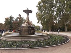 Fuente de los Galapagos fountain in El Retiro park, Madrid with Puerta de Alcalá in the background