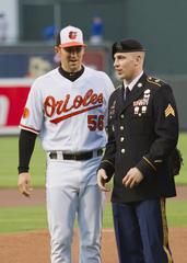 Baltimore Orioles pitcher Darren O'Day talks with Sgt. Ryan Barger of the 423rd Military Police Company during a Major League Baseball game