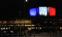 Finlandia Hall illuminated with blue, white and red lights of the French tricolore