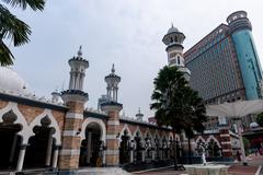 Sultan Abdul Samad Jamek Mosque in Kuala Lumpur with intricate architecture and blue sky